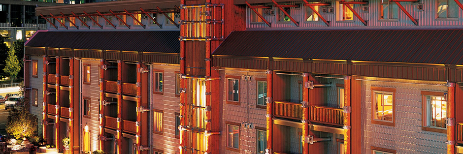 Steel and timber facade lit up at night